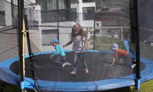 two girls and two boys playing on a trampoline at Apart Christine - Silvrettacard-Sommer inklusive in Galtür