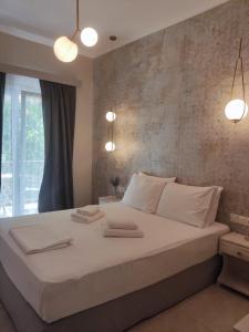 1 dormitorio con 1 cama grande con sábanas blancas en Villa Chrisanthi, en Parga