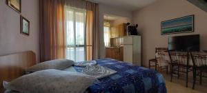 a bedroom with a bed with a blue comforter at Villa Madani in Durrës +12 photos