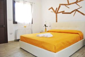 a bedroom with a bed with two towels on it at B&B Monteleo Salento in Morciano di Leuca