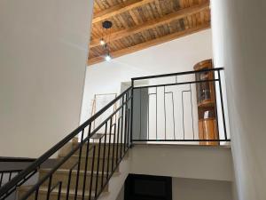 a staircase in a house with a wooden ceiling at Casa Beach in Balestrate