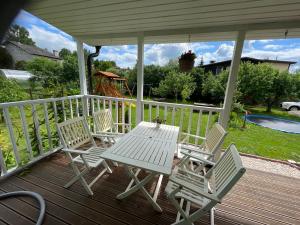 a white table and chairs on a porch at Aunt Owl’s House in Vissi