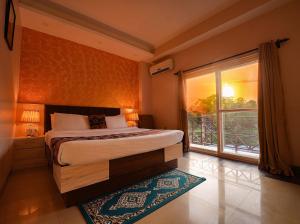 a bedroom with a bed and a large window at Hotel 360 by D'Polo Dharamshala in Dharmsāla
