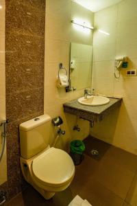 a bathroom with a toilet and a sink at Hotel 360 by D'Polo Dharamshala in Dharmsala
