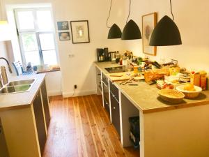 a kitchen with a counter top with lots of clutter at Künstler-Wohnraum in Beverungen