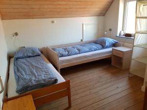 um pequeno quarto com uma cama e uma janela em Hus til stor familie em Bredebro