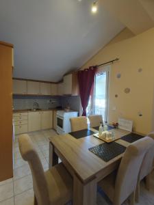 a kitchen with a wooden dining table and chairs at John's Apartment 4 in Argostoli in Argostoli