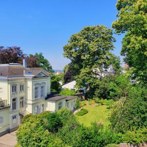 a large white house with a green yard at Ferienwohnung Fernblick in Remscheid
