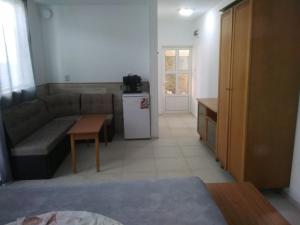 a living room with a couch and a table at Къща за гости Орлите in Ahtopol +10 photos