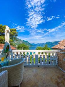 a balcony with a view of the water and mountains at Lovely apartment Jovan 3,with a view of the bay and free Wi-Fi in Kotor
