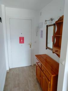a room with a door and a mirror and a dresser at Apartments Las Vinas in Denia +25 photos