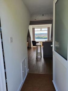 a room with a hallway with a table and a window at Seasidesteps in Fishguard