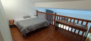 a bedroom with a bed and a wooden floor at Gite de POUNARD bord de rivière plage privée 