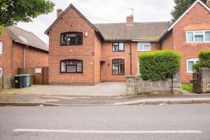 a large brick house with a street in front of it at Manor Team Hse, M6 J10, Free Secure Onsite Parking, 8 beds in Walsall