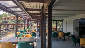 a restaurant with tables and chairs on a balcony at Glavatarski Han in Glavatartsi