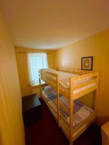 a bedroom with two bunk beds and a window at Morena Liux Apartment in Klaipėda