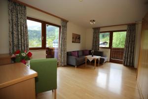 a living room with a couch and a table at Haus Alexander in Schladming