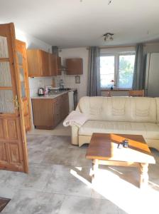 a living room with a couch and a table at Sawanna in Gołubie