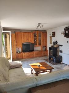 a living room with a couch and a tv at Sawanna in Gołubie