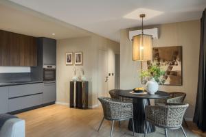a kitchen and dining room with a table and chairs at Oltremare Premium suite apartment w/pool in Rabac in Rabac