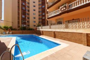 a swimming pool in an apartment with a building at CT 178 - Versalles City Apartment - Fuengirola in Fuengirola