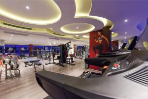 a fitness room with a gym with exercise equipment at Grand Avenue Condo by Bormon in Pattaya Central