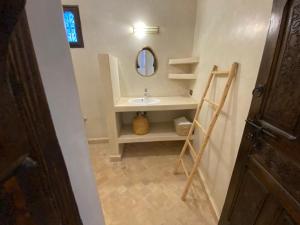 a bathroom with a sink and a mirror at Dar Mamoun in Marrakesh