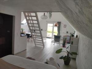 a bedroom with a staircase leading to a living room at *** Biezoe *** in Brakel