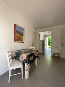 a room with a table and chairs and a kitchen at Motel Esterel in Mandelieu-La Napoule