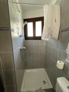 a bathroom with a shower and a toilet and a sink at Motel Esterel in Mandelieu-La Napoule +16 photos