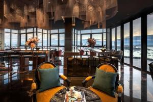 a hotel lobby with chairs and tables and windows at EDGE Central pattaya near walking street in Pattaya Central