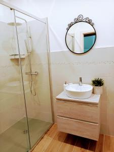 a bathroom with a sink and a mirror at B&B Il Ghiro in Riolunato