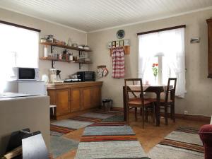 a kitchen and dining room with a table and chairs at Abbis lillstuga in Norra Vallgrund