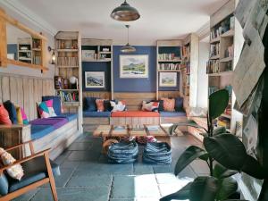 a living room with a couch and a table at The Rocks at Plas Curig Hostel in Betws-y-coed