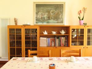 a dining room with a table and a book shelf at Bed and Breakfast La Cesura in Mattarello