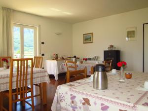 a dining room with two tables and chairs and a room with two tables at Bed and Breakfast La Cesura in Mattarello