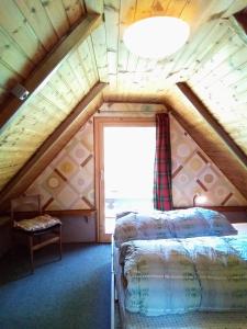 a room with two beds and a window at Il nido (Cica) in Sottoguda