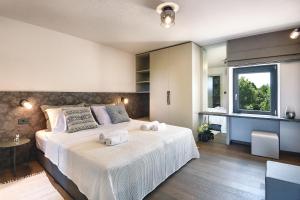 a bedroom with a large bed with towels on it at Casa Evina in Krnica +37 photos
