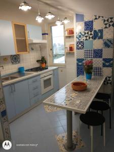 a kitchen with a table and chairs in it at IDA S Apartament in Pontecagnano