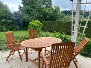 a wooden table and chairs on a patio at EG Apartment - WLAN - Terrasse - Parkplatz in Buchenberg