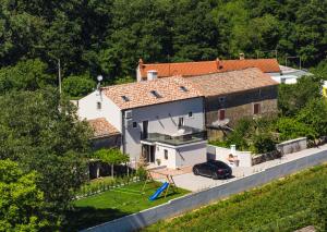a house with a car parked in front of it at Casa Evina in Krnica