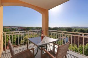 patio con mesa y sillas en el balcón en Villa Tade en Debeljak