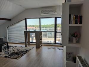 a living room with a table and a large window at Apartment 7 in Tsarevo