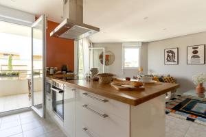 a kitchen with white cabinets and a counter top at SIROCCO - Bel appartement avec extérieur proche des plages in Marseille +6 photos