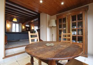 a dining room with a wooden table and chairs at GITE DU HABLE in Omonville-la-Rogue