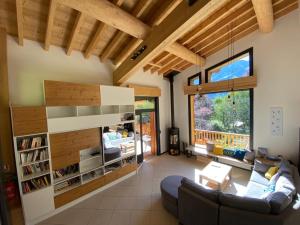 a living room with a couch and a table at Chambres d'hôtes - B&B - Chalet Mountain Vibes in Les Houches