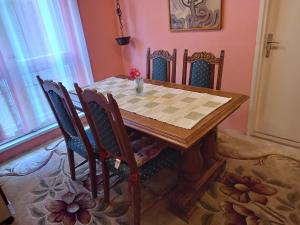 a dining room table and chairs with a chessboard on it at Oriental Apartment in Plužine