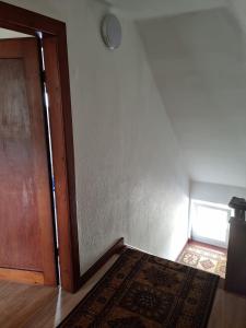 an empty room with a door and a rug on the floor at Ferienwohnung in Barntrup