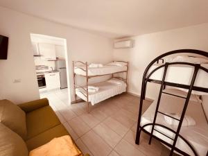 a living room with two bunk beds and a couch at Hotel Damma's, Dipendenza Zamagna in Cesenatico +29 photos