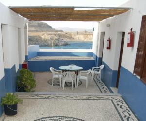 a table and chairs on a patio with a view of the ocean at Eugenia villa in Lindos